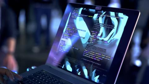 image of a close up of hands on a laptop at a Drupal event