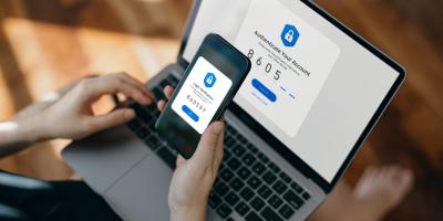 Color photo of someone using MFA to log in