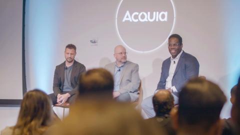 Speakers at an Acquia engage event presenting on stage