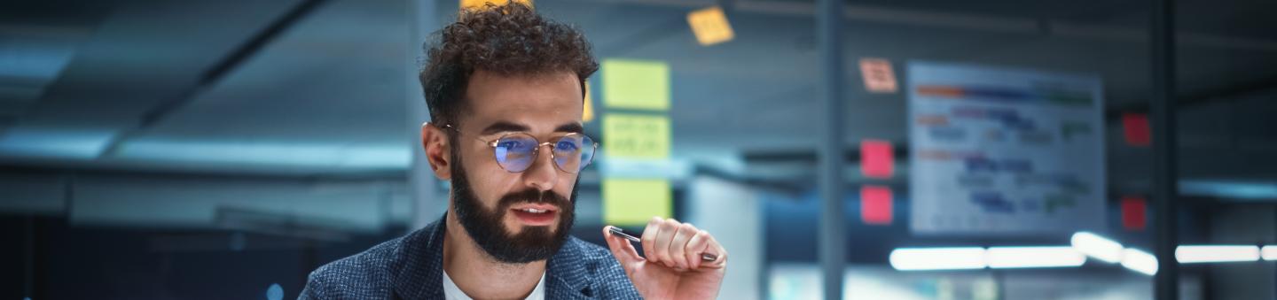 Person sitting at desk looking at laptop