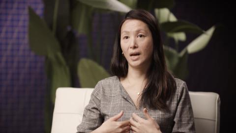 Judy Liang speaking in a lounge