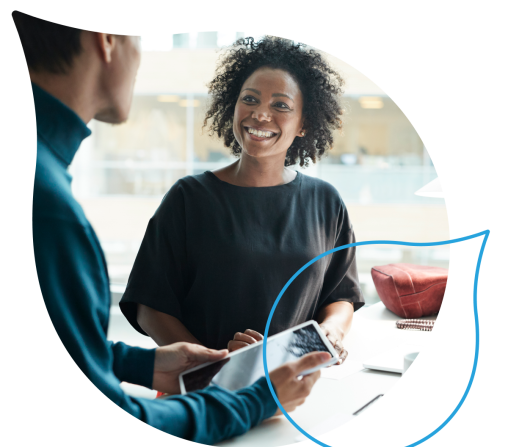 two people speaking while one holds a tablet masked by the acquia droplet