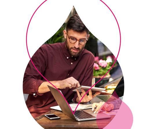 person on a laptop cropped by an acquia droplet surrounded by pink droplets