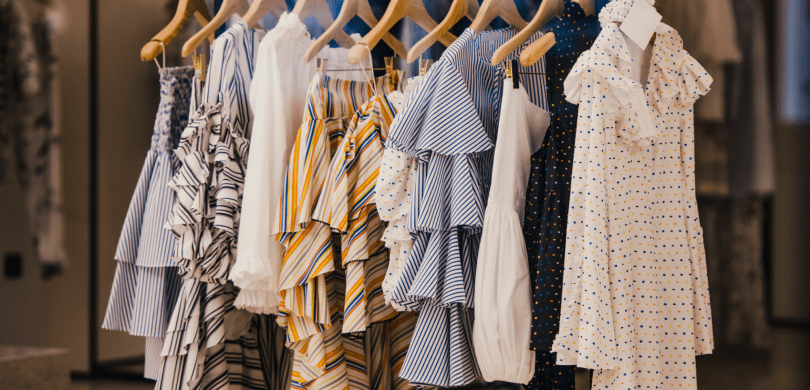 Clothing rack with dresses and shirts