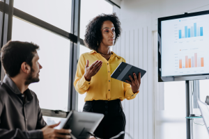 Woman standing with tablet, giving presentation