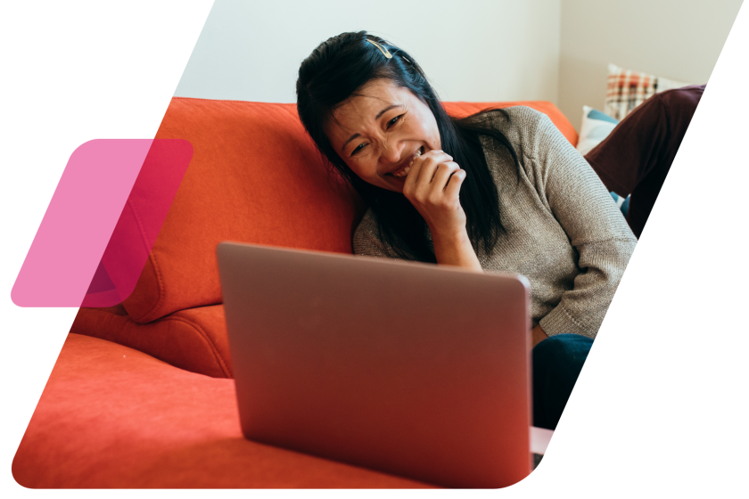 image of a person watching something on their laptop on a red couch masked by a parallelogram