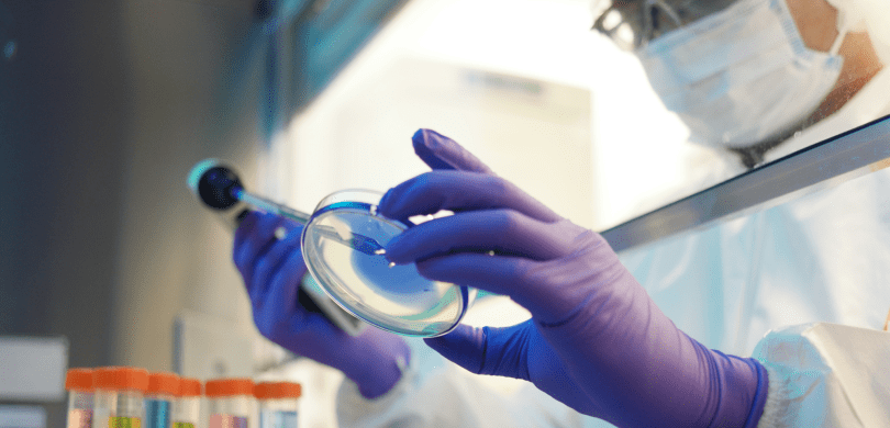 Scientist holding Petri dish